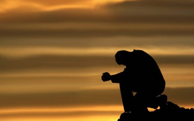 man praying facing trials